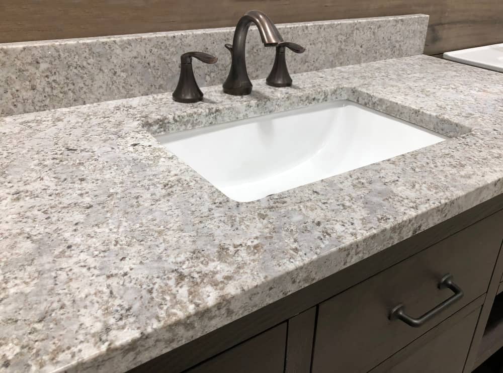 rectangular white sink under granite countertop